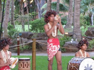 Hawaiian Conch Shell Blower in Traditional Attire